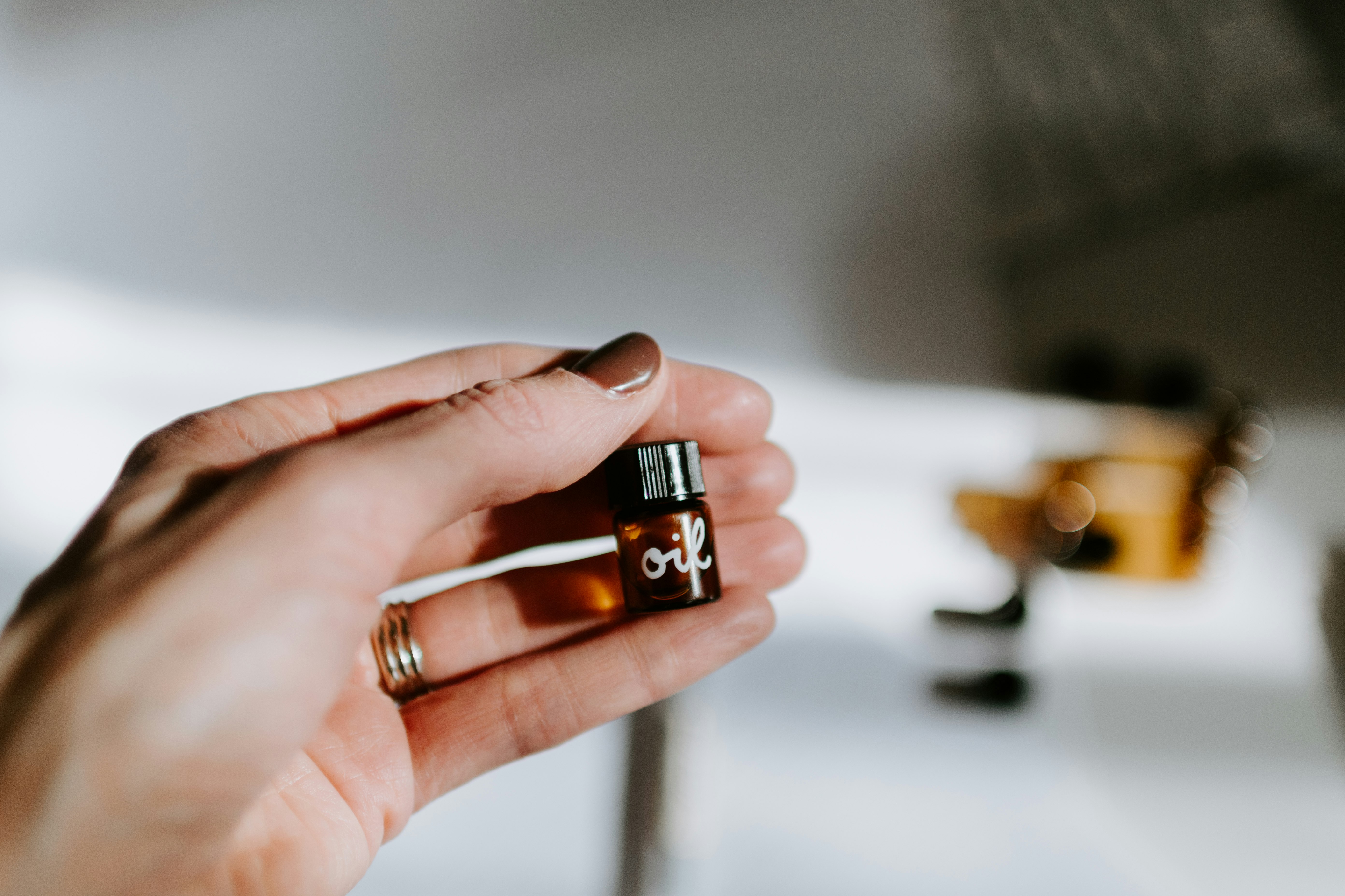 person holding brown glass bottle